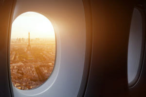 A view of Paris from inside a dimly lit airplane